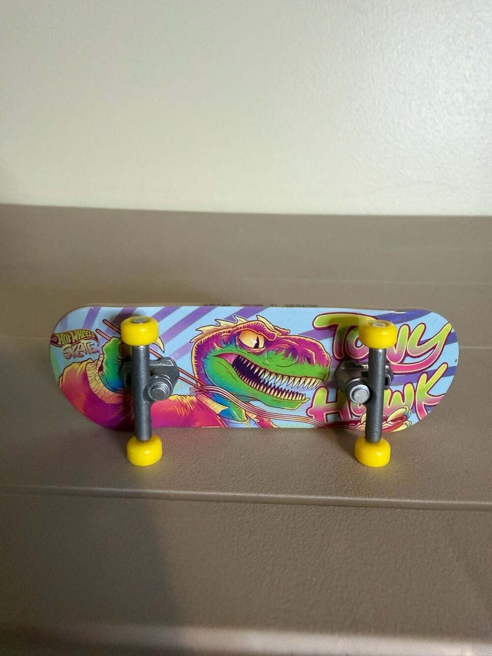 Hot Wheels Skate Tony Hawk Dino Graphic Fingerboard with French Fry Graphic Grip